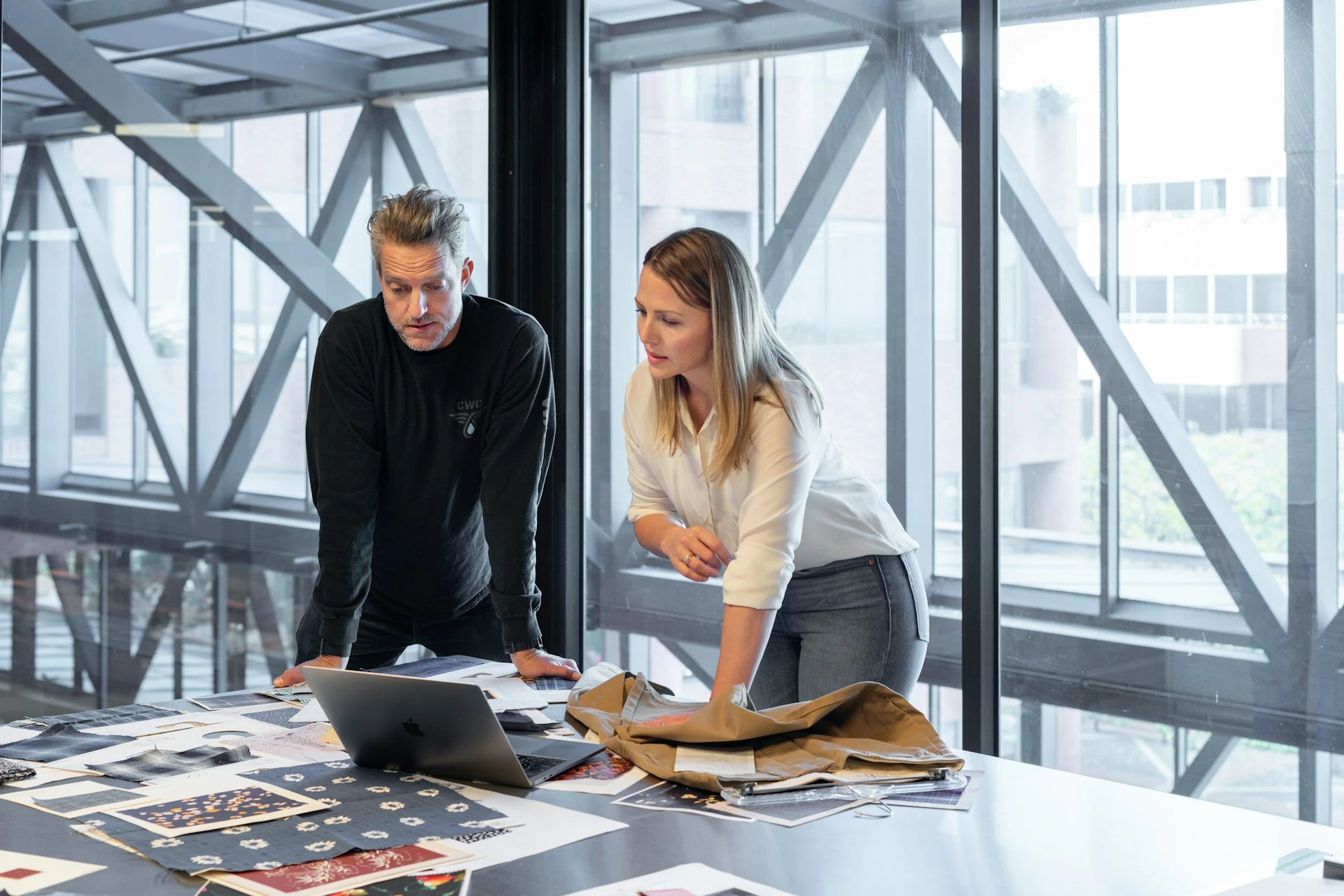 Two people discussing while standing in an office